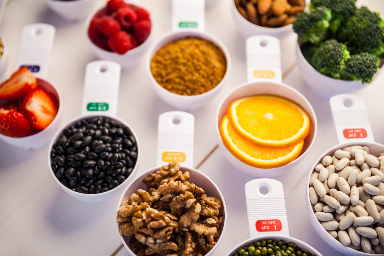 Portion cups of healthy ingredients on wooden table