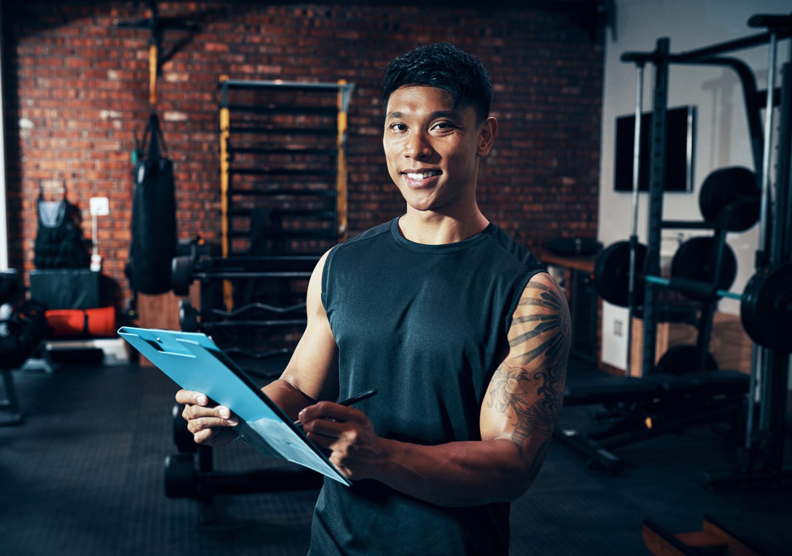 Would you like to be a member. Shot of a personal trainer holding a clipboard