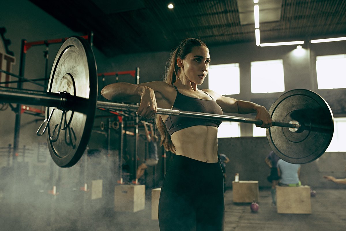 fit-young-woman-lifting-barbells-working-out-in-a-ZJ6VX3C.jpg